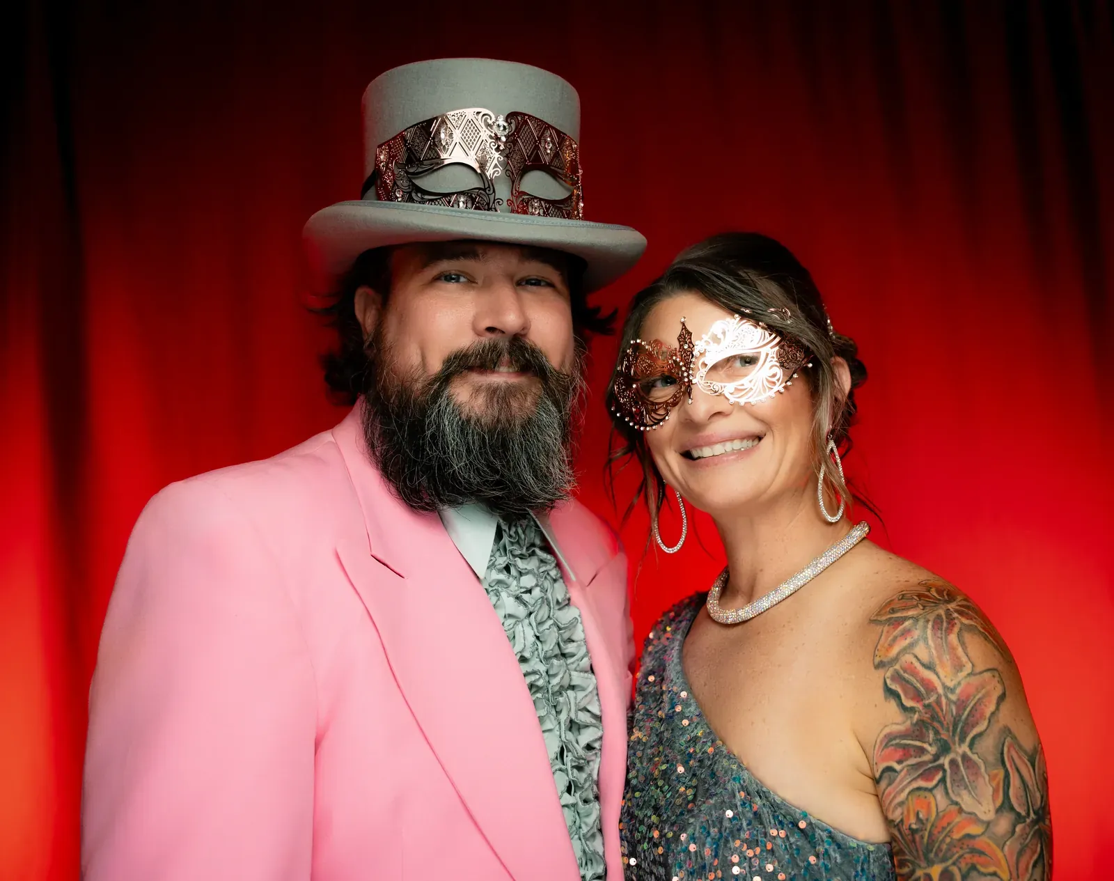 Guests in masks on the dance floor bathed in purple light.