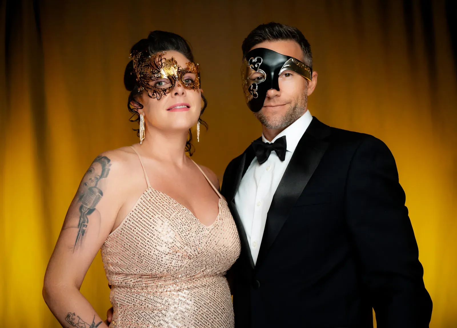 Guests laughing during a toast under dramatic lighting.