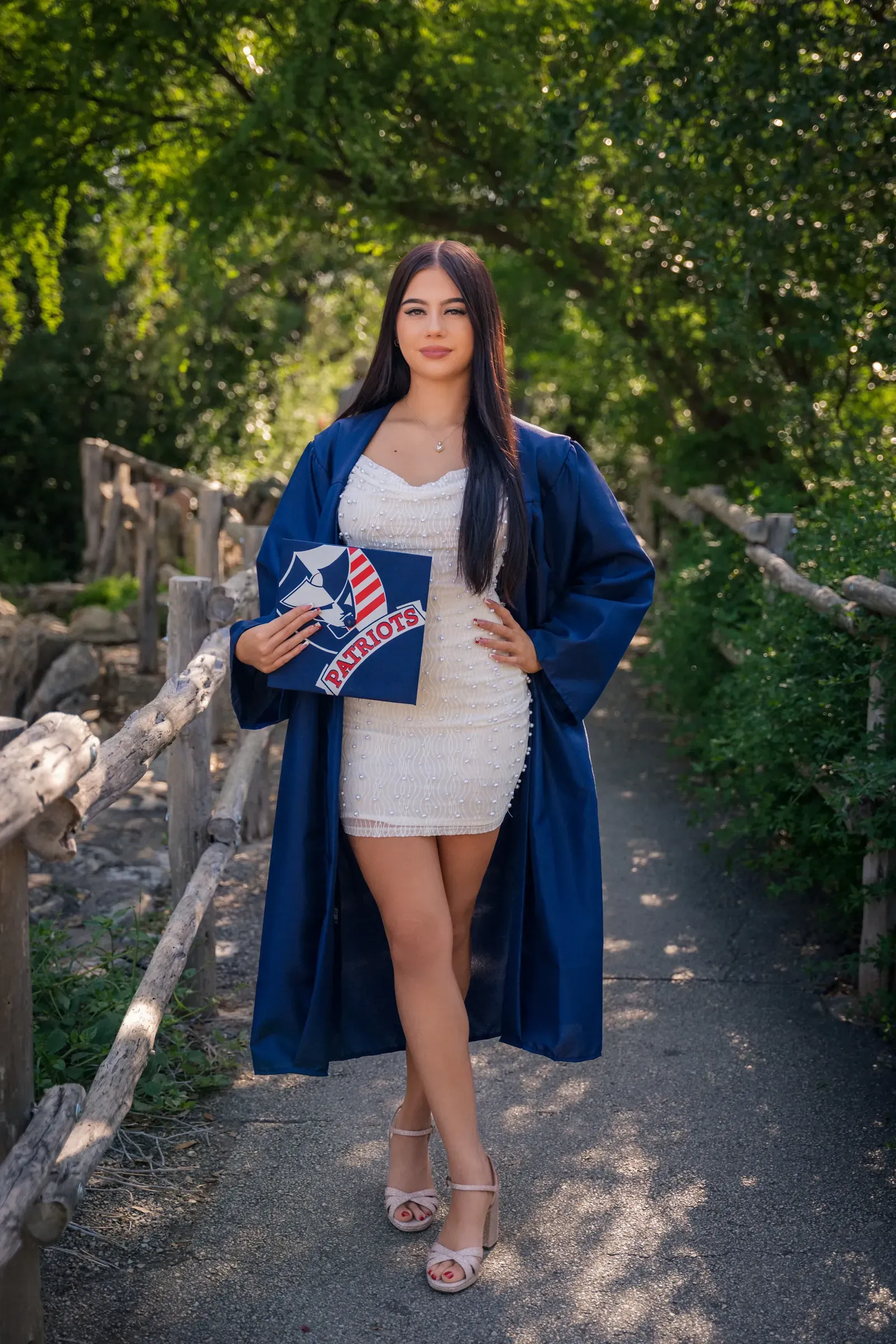 Tayla leaning against a mural with sunlight hitting her shoulder.