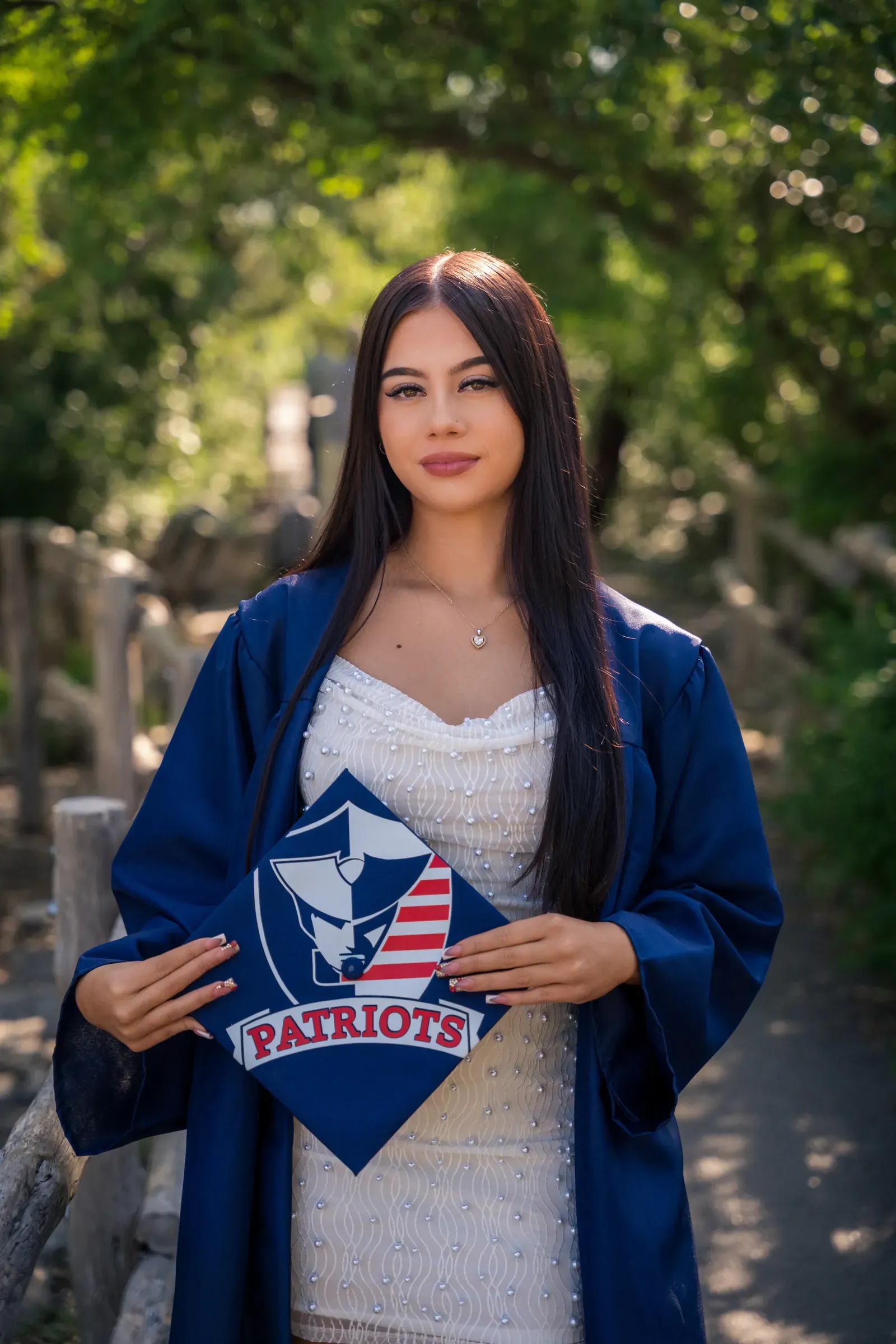 Senior portrait of Tayla smiling in a city alley.
