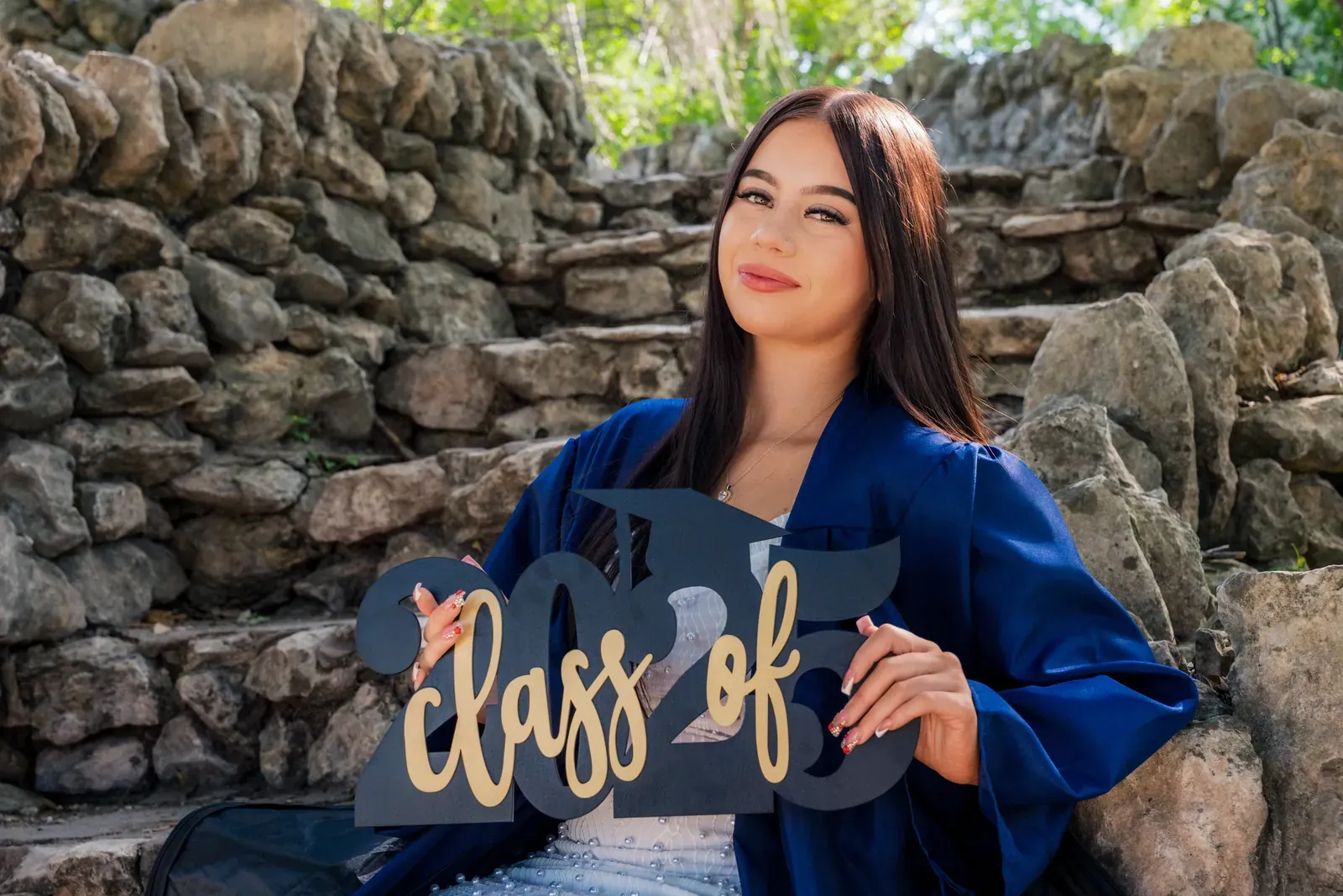 Tayla walking down steps with a grad cap in hand.