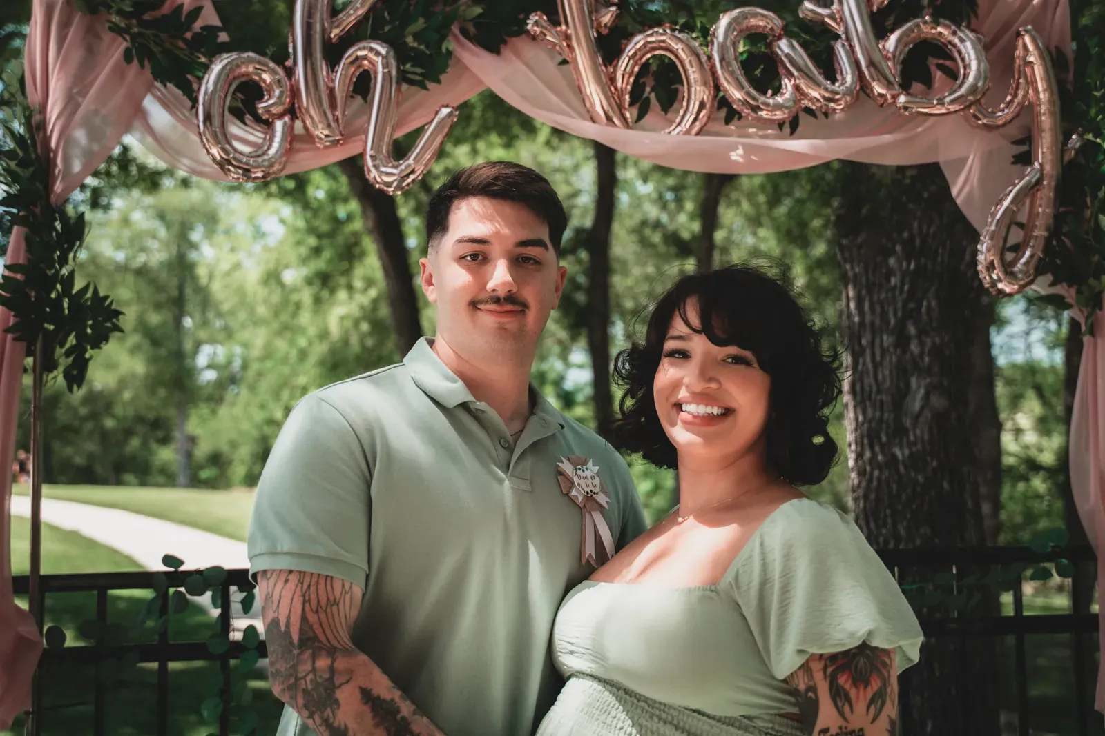 Guests embracing in front of a backdrop.